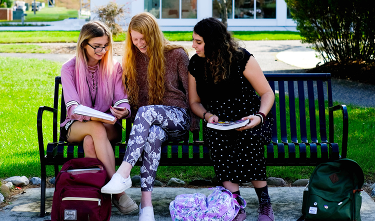 storesoo.com three female students studying on a bench on camp at Ocean County College